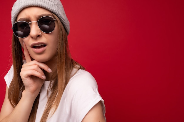 Closeup of young dissatisfied thoughtful emotional beautiful dark blonde woman with sincere emotions