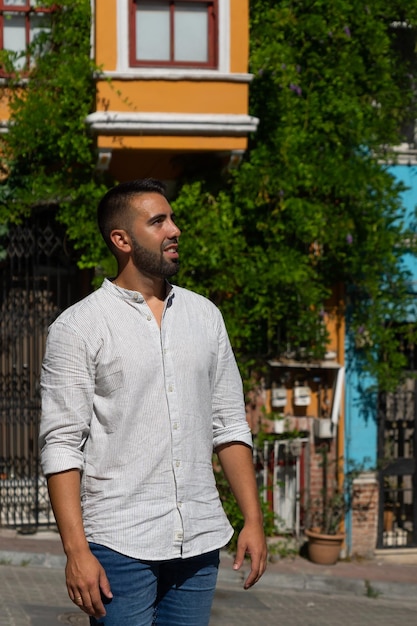 Closeup of a young man on an Istanbul street with colorful buildings