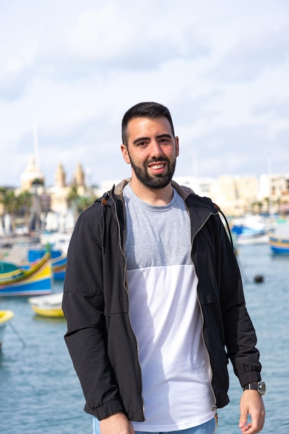 Closeup of young man visiting Marsaxlokk Malta