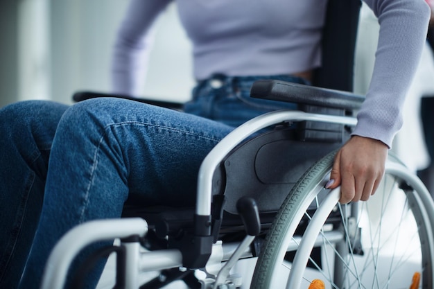 Photo closeup of young woman at wheelchair in hospital