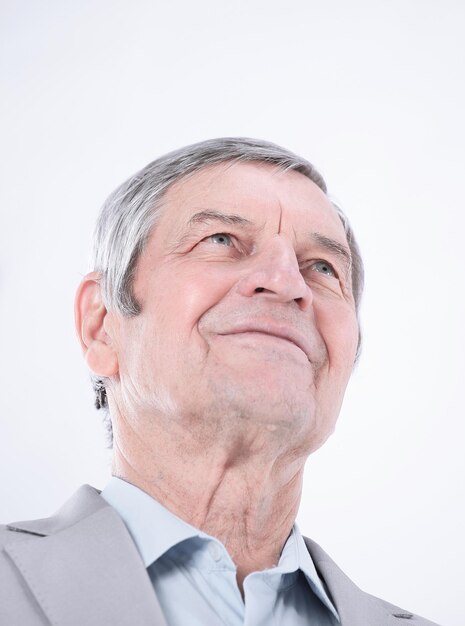 Closeupconfident senior businessman looking up at copy space