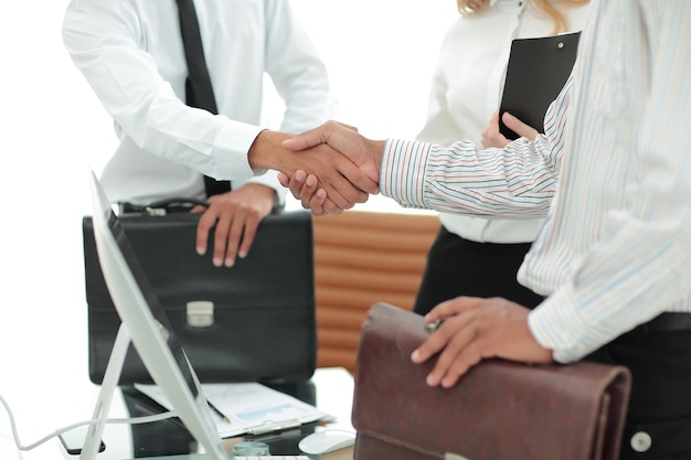 Closeuphandshake of business people on the background of the office