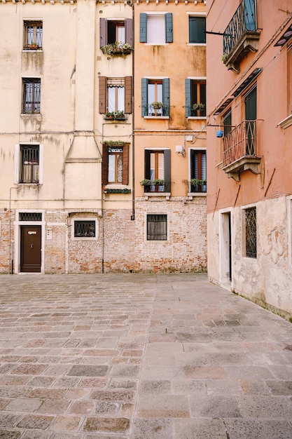 Closeups of building facades in venice italy ancient street facades of peach and yellow buildings