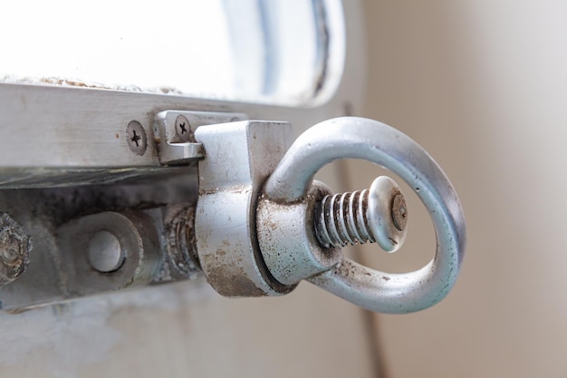 Closing mechanism of the ship's porthole in the form of a clamp on a threaded pin and a screw handle