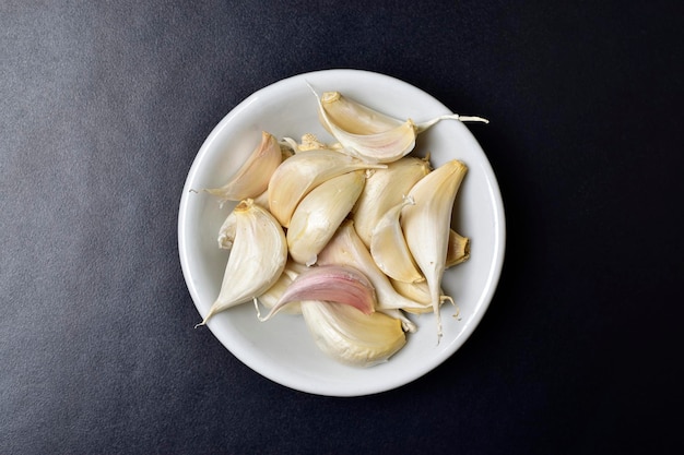 Closuep of garlic in bowl on dark background