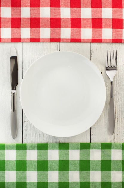 Cloth napkin and plate on wooden wall