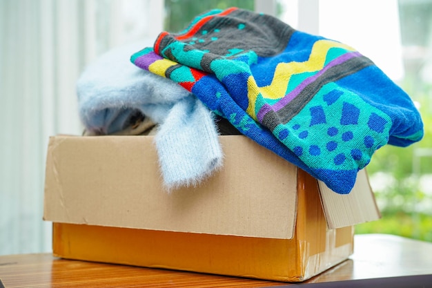 Clothes donations in cardboard box for volunteer