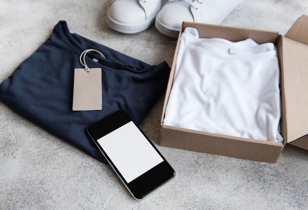 Clothes in an open cardboard box Online shopping concept Delivery of clothes