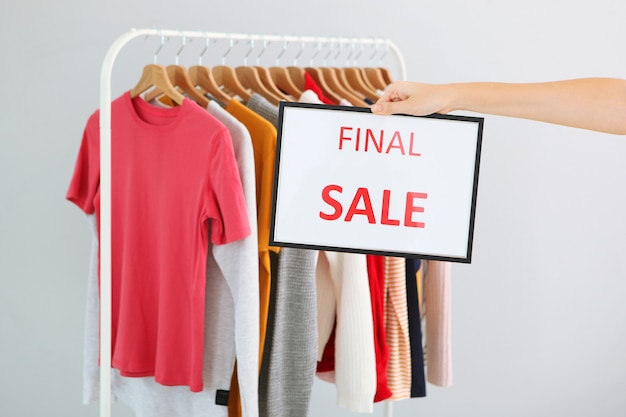 Clothes on the rail and a sale sign Final sale discounts