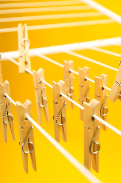 Clothespins hanging on drying rack close up