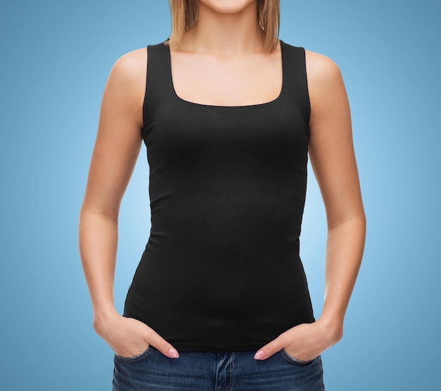 clothing design, fashion, advertisement and people concept - close up of woman in blank black tank top over blue background