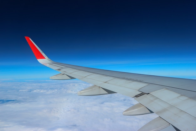 Above the cloud blue sky view from airplane window.