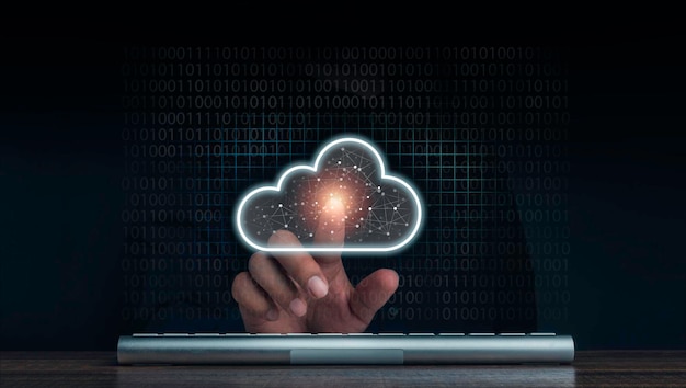 Cloud computing technology concept. Cloud icon virtual appeared while man pointing finger and keyboard computer with network and coding on dark background. Network data storage technology service.