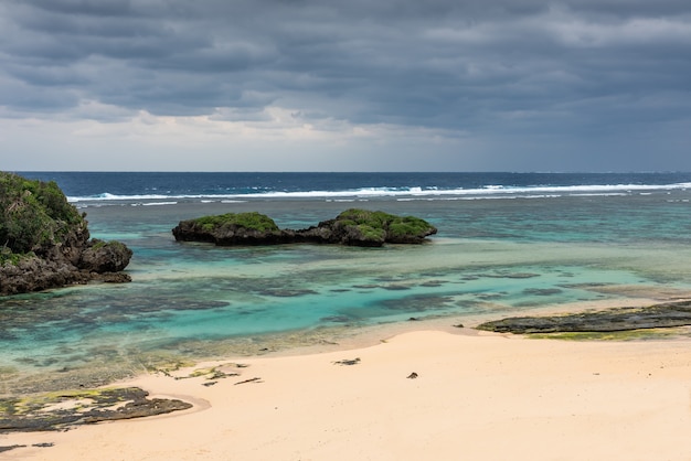 Cloud day at Hoshizuna beach gray clouds polarized turquoise sea coral reef Iriomote Island