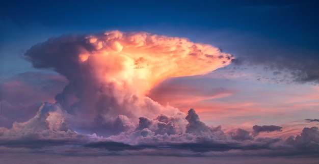 Cloud in the form of a nuclear explosion. Bright sky at sunset or sunrise.