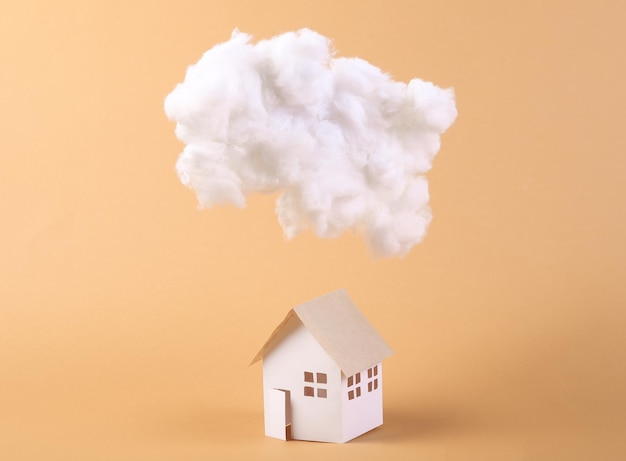 Cloud and house model on beige background Concept art Minimalism