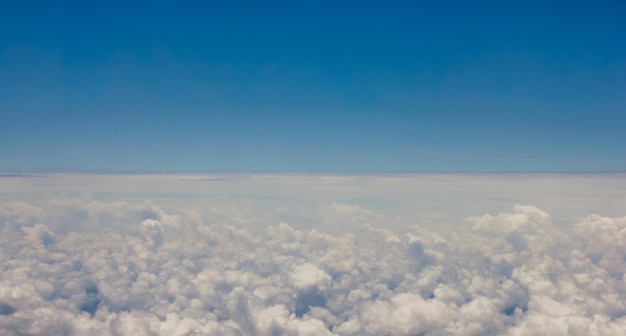 Cloud layer seen from top to bottom through the airplane window during a trip