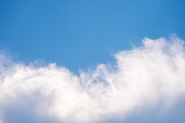 A cloud in the sky with a blue background.