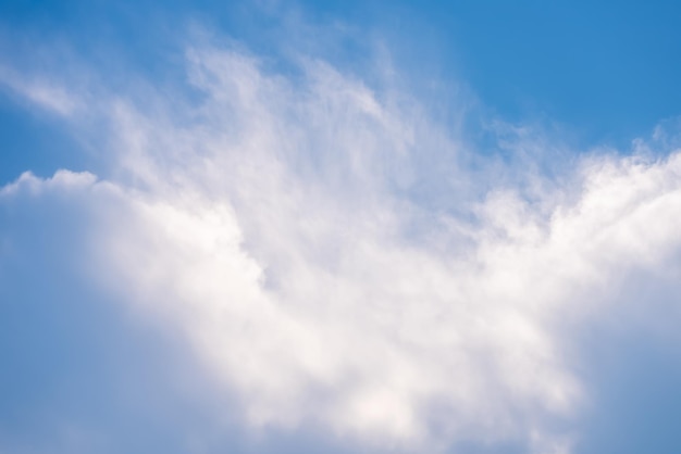 A cloud in the sky with a blue sky in the background.