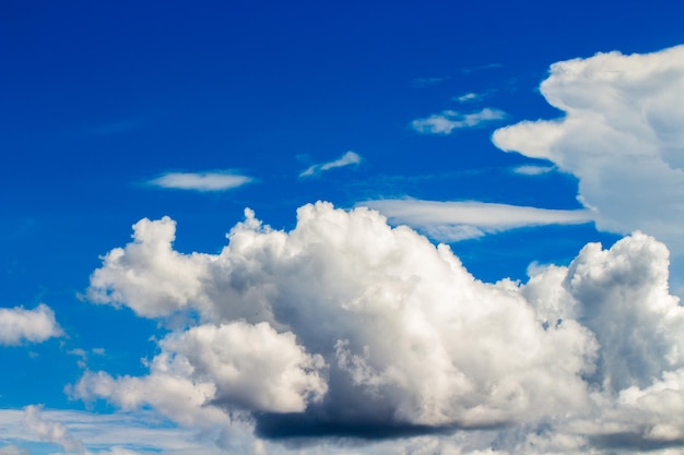 A cloud in the sky with a blue sky in the background