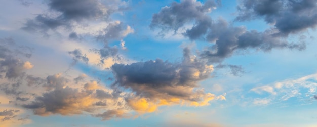 Clouds in the blue sky illuminated by the evening sun