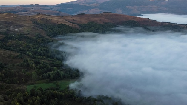 Clouds covering forest and hills in Romania