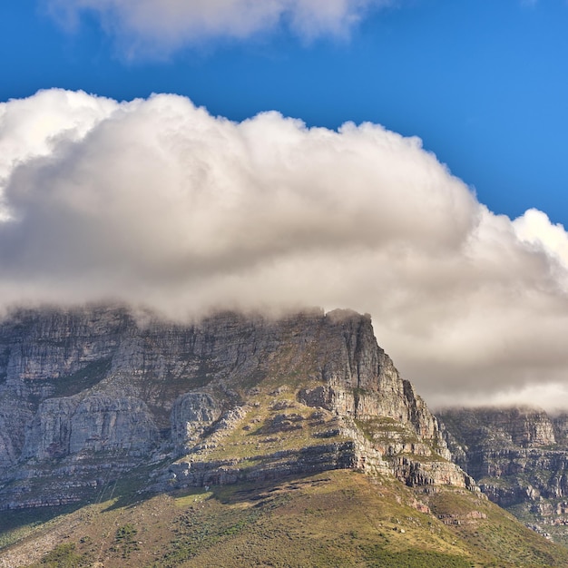 Clouds covering top of Table Mountain Cape Town with copyspace Cloud shape and shadow over rocky terrain on a sunny day beautiful calm nature in harmony with scenic views of plants and landscape