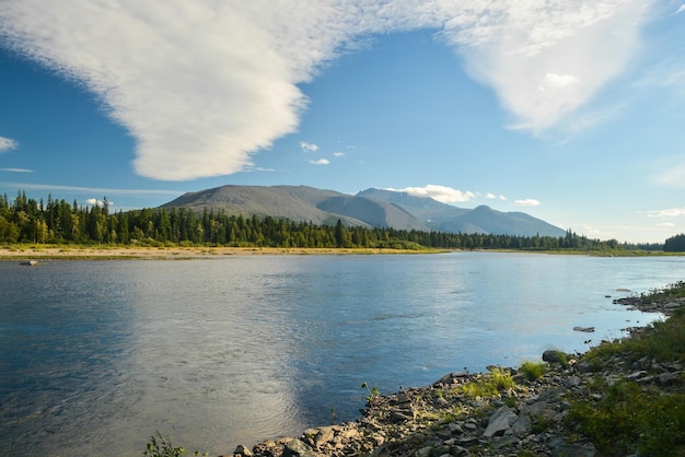 Clouds over Mount Telposiz are reflected in the Schugor River