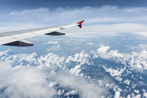 Clouds and sky as seen through window of an aircraft