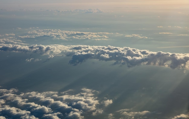 Cloudscape background at sunrise View out of a plane window