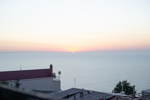 Cloudscape over the sea in the sunrise near the city