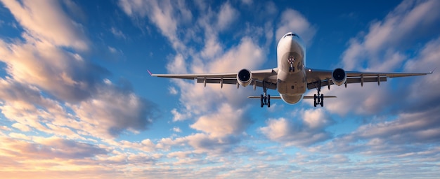 Cloudscape with white passenger airplane flying