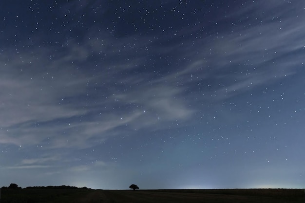 Cloudy Night sky with stars. Night background. Night sky.