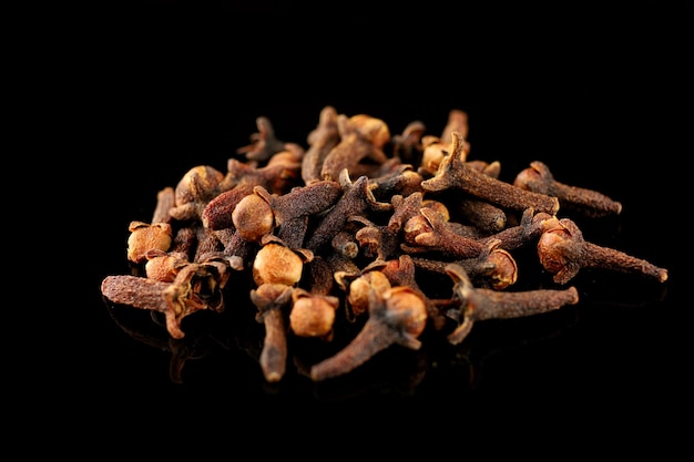 Clove spice pile on black isolate