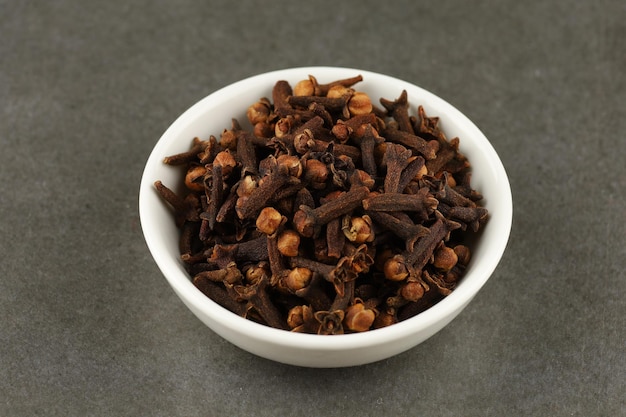 Clove spice in a white ceramic vessel