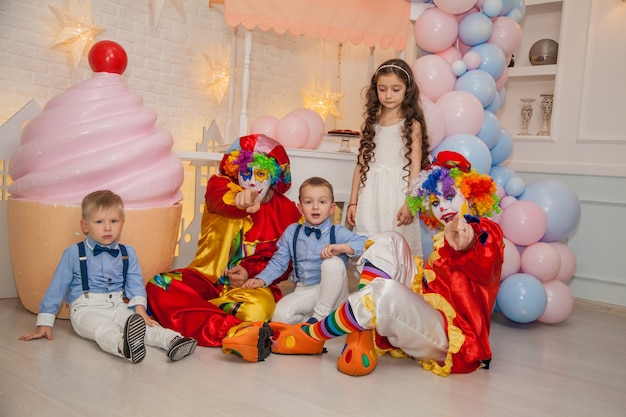 Clown boy and clown girl on childrens party having fun with children