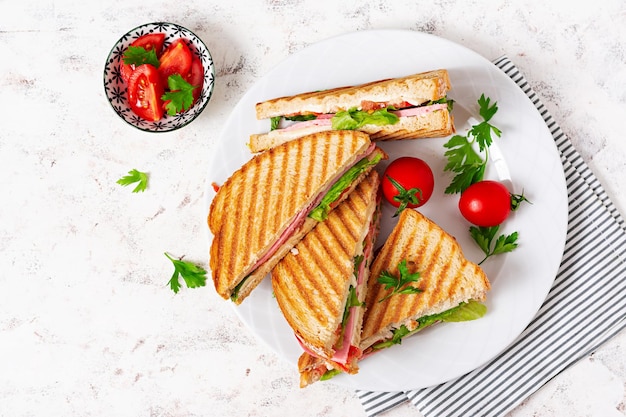 Club sandwich panini with ham tomato cheese and lettuce Top view