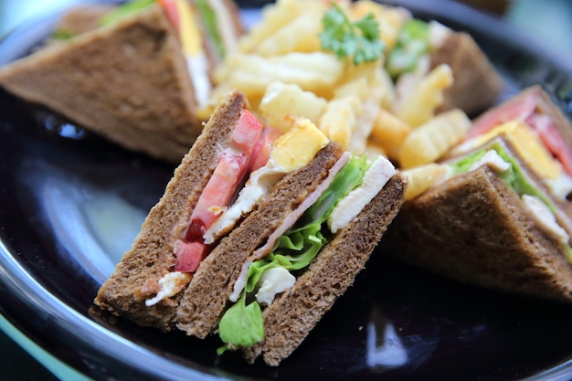 Club sandwich , Sandwich with chicken tomato chicken bacon and vegetable