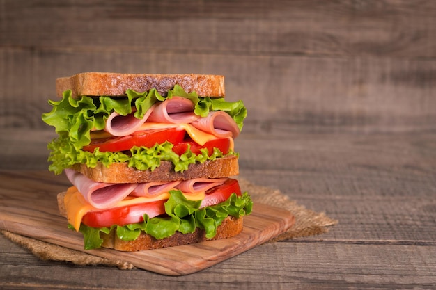 Club sandwich with ham, cheese, tomato and lettuce.