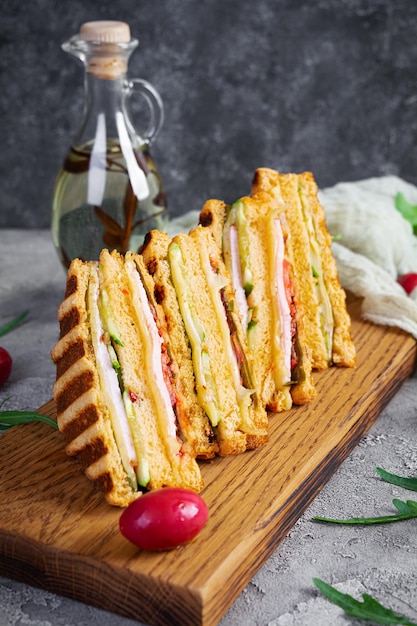 Club sandwich with ham cheese tomato and salad Grilled sandwich with dried tomatoes bread