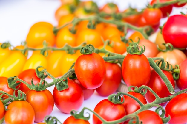 cluster of cherry tomatoes on the white background