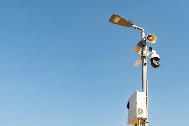 Cluster of security cameras on a lamppost in an public Park on the sky background with copy space