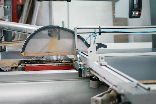 Cnc circular saw sawing chipboard Process of making cabinet furniture closeup