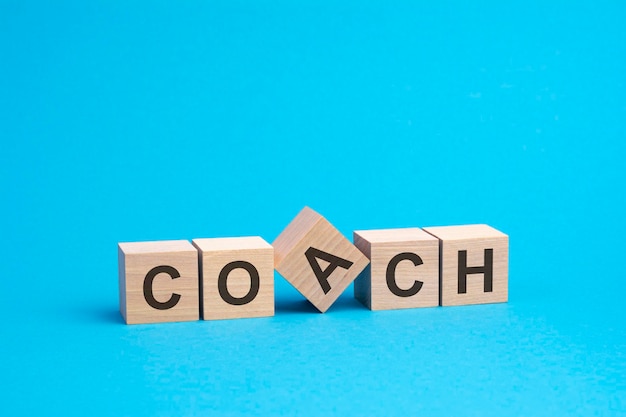 Coach text on wooden blocks business concept blue background