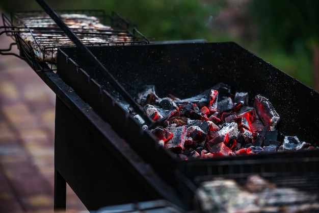 coals are burning in the barbecue in nature for cooking meat on fire