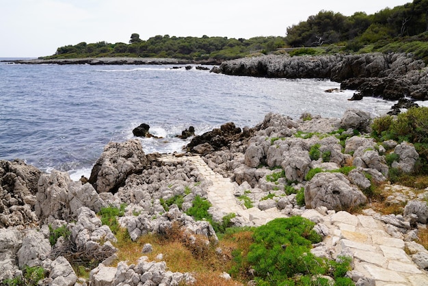 Coast access mediterranean sea patway to rock beach coast JuanlesPins in Antibes France