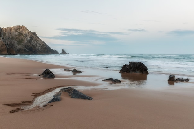 Coast of Portugal, cape Kabo-da-Roca. Picturesque, the freakish form of a rock on the bank of Atlantic ocean.