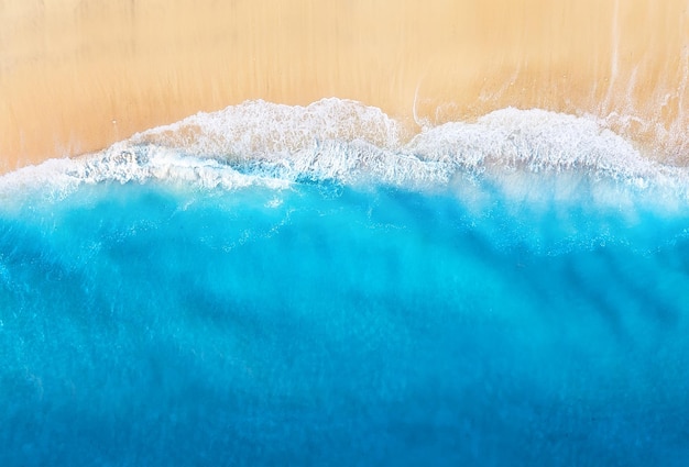 Coast with waves as a background from top view Blue water background from drone Summer seascape from air Travel image