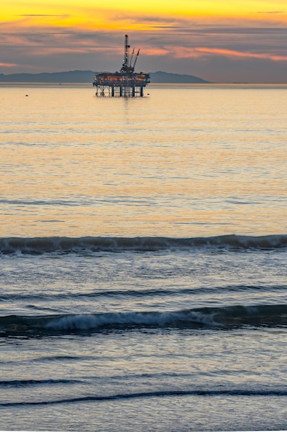 Coastal Convergence Oil Rig and Surfer at Huntington Beach California Harmoniously Uniting in 4k