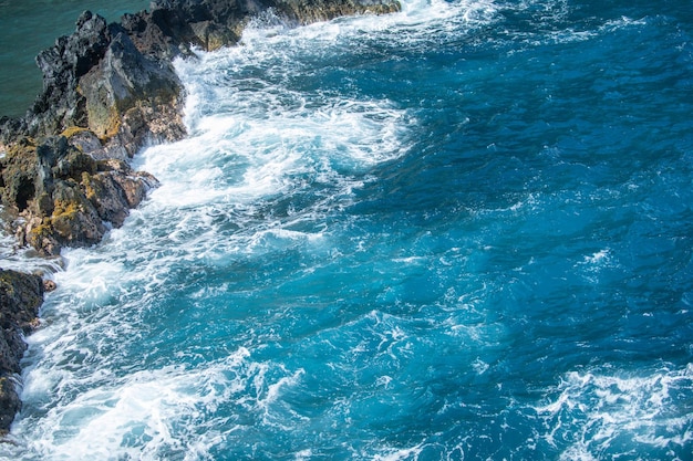 Coastal landscape with blue sea and beautiful cliffs stone rocks on coast in blue water